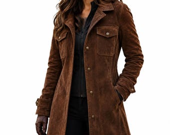 May include: A dark brown suede jacket featuring a collared neckline, a button-down front closure, and two chest pockets with buttoned flaps. The long-sleeved jacket includes buttoned cuffs and a structured fit, worn over a black zip-up garment.