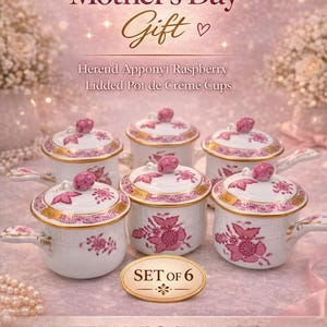 May include: Set of six Herend Apponyi Raspberry Lidded Pot de Crème Cups. Each white porcelain cup features a pink floral design, gold trim, and a pink knob on the lid. The image includes the text "Mother's Day Gift".