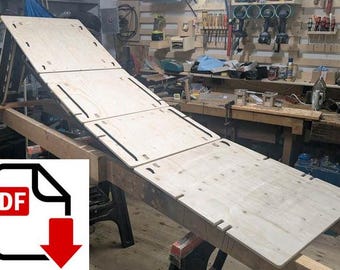 May include: A wooden ramp structure with multiple connected panels. The ramp is constructed from light-colored plywood and features black reinforcement strips. The design appears to be for a woodworking project or similar application.