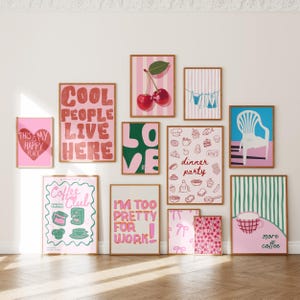 May include: A selection of framed art prints with diverse designs and text. The prints showcase illustrations of cherries, a chair, and phrases such as "Cool People Live Here" and "Coffee Club". The colour scheme incorporates pink, green, and white.