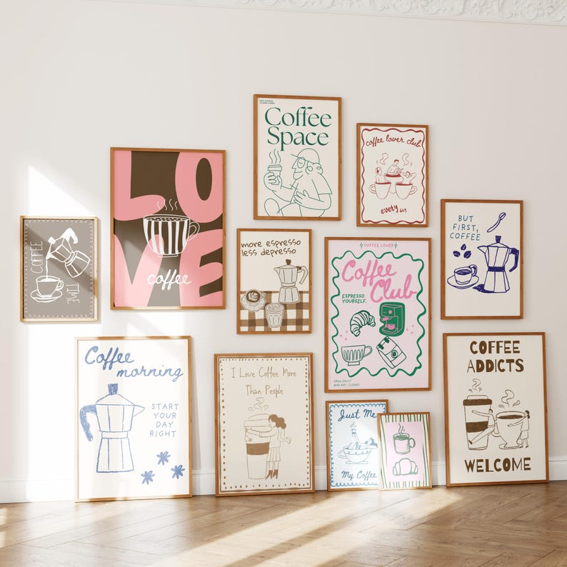 May include: A collection of framed art prints with coffee-themed illustrations and text. The prints feature various designs, including coffee cups, coffee makers, and phrases like "Coffee Space" and "Coffee Club". The frames are brown.