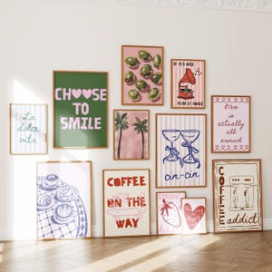 May include: A collection of framed art prints with various designs and text. The prints feature images of olives, palm trees, coffee, strawberries, and phrases like "Choose to Smile" and "Coffee on the Way."