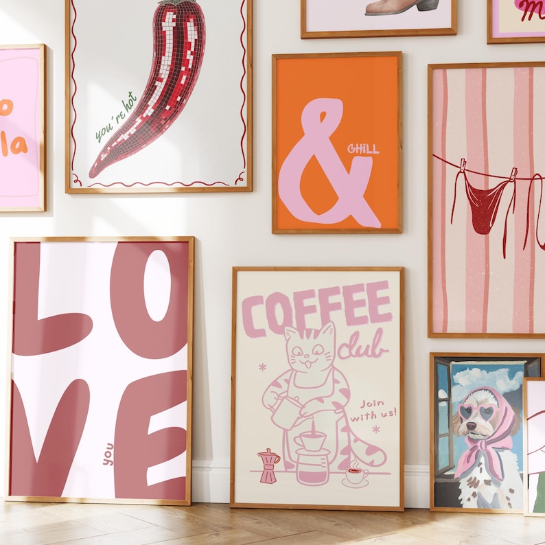 May include: Collection of framed art prints with various designs. Includes a red chili pepper mosaic, an ampersand with "CHILL", a "COFFEE CLUB" cat illustration, and a "LOVE" print. The prints have a retro, whimsical style.