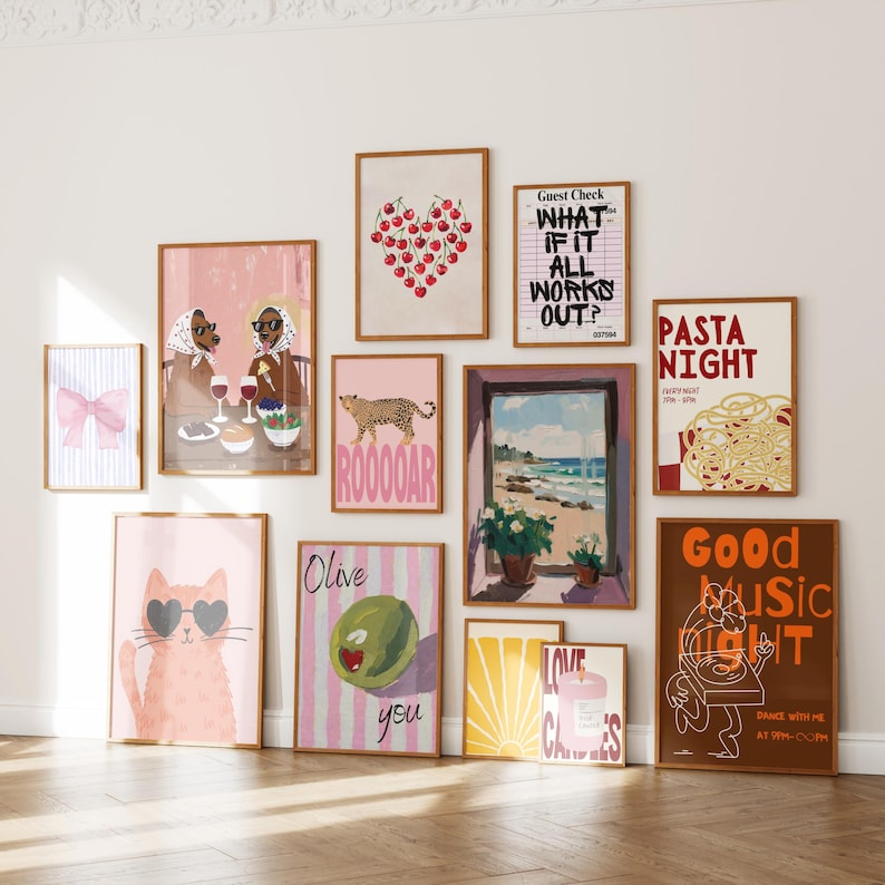 May include: A collection of framed art prints with various designs. The prints include a pink bow, a heart made of cherries, a leopard, a cat wearing sunglasses, and text that reads "WHAT IF IT ALL WORKS OUT?" and "PASTA NIGHT". The frames are brown.