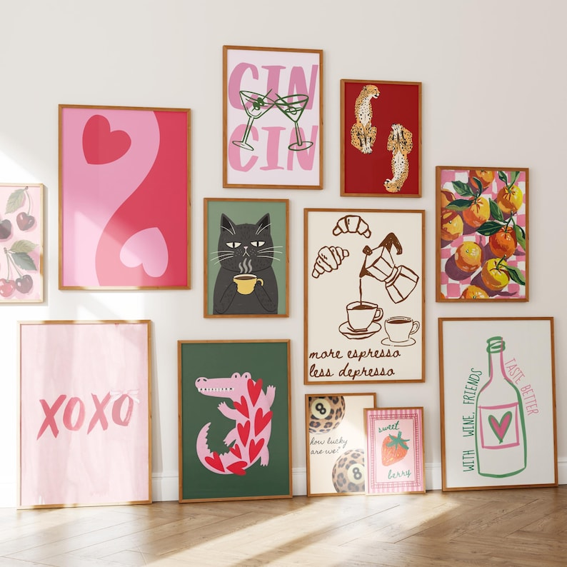 May include: A collection of framed art prints with various designs. Prints include a yin-yang heart, a cat drinking coffee, a crocodile with heart shapes, and the text "XOXO". Other prints feature cocktails, fruit, and the text "more espresso less depressa".