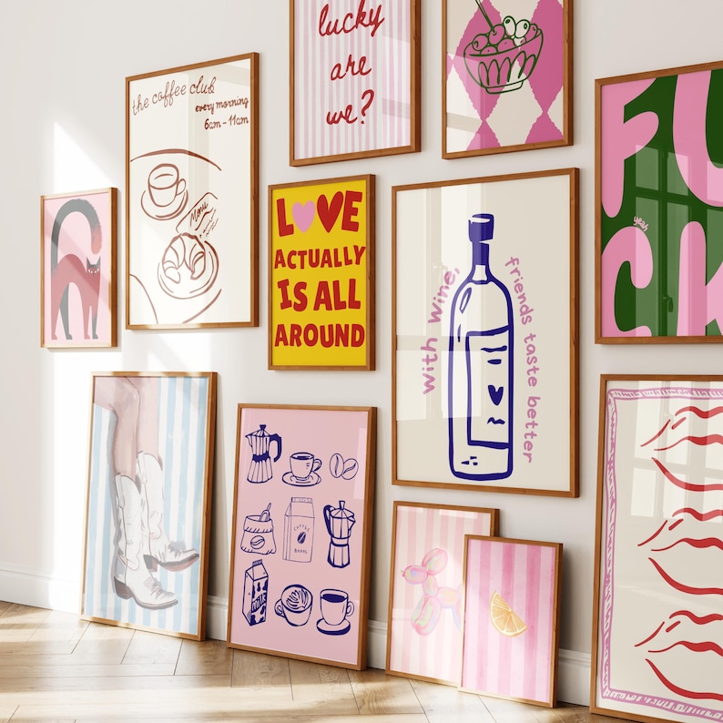 May include: A selection of framed art prints with diverse designs. Prints feature text such as "the coffee club", "lucky are we?", and "LOVE ACTUALLY IS ALL AROUND". Other prints display illustrations of a wine bottle, coffee, and abstract art. The frames are brown.