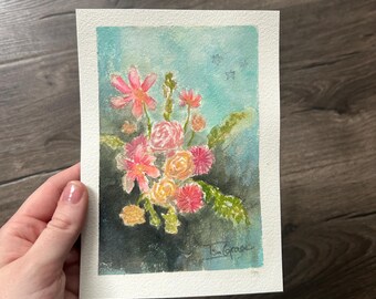 May include: A rectangular watercolor painting on textured paper featuring a bouquet of pink, orange, and yellow flowers against a blended teal and dark green background. The artwork includes small star shapes and a signature in the bottom right corner.