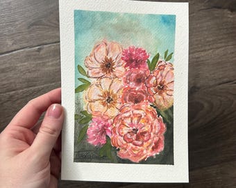 May include: A rectangular watercolor painting on textured paper featuring a vibrant bouquet of pink, peach, and coral flowers with green leaves. The background transitions from a soft blue at the top to a deep, dark green at the bottom.