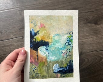 May include: A rectangular painting on textured white paper featuring abstract layers of paint in shades of blue, green, yellow, and pink. The composition includes dark navy brushstrokes, light blue washes, and a series of small hand-drawn circles.