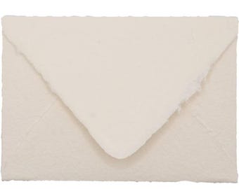 May include: Cream-colored envelope with a textured, handmade paper appearance. The envelope has a triangular flap and a rough, torn edge, suggesting a rustic or artisanal aesthetic. Ideal for stationery or invitations.