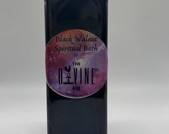 May include: A square, clear bottle filled with a dark liquid, topped with a black cap. A circular label features the text "Black Walnut Spiritual Bath" and the brand name "The Divine". The label has a purple and pink background.