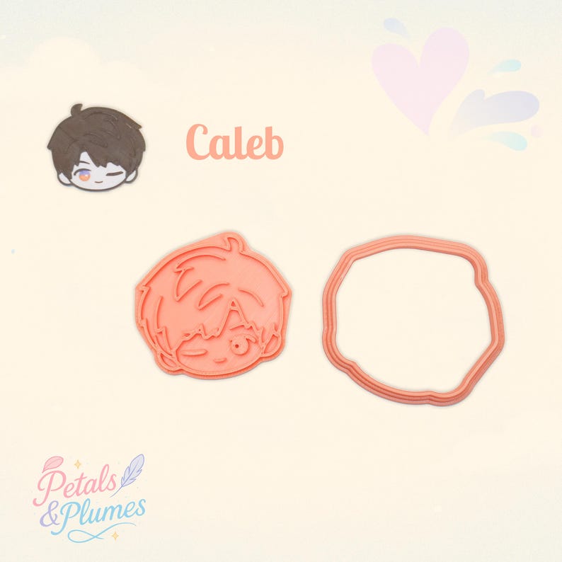 May include: A peach-colored plastic cookie cutter set featuring a character head with short hair and a winking eye, alongside a matching circular outline cutter. The text Caleb is printed in peach above the character illustration.