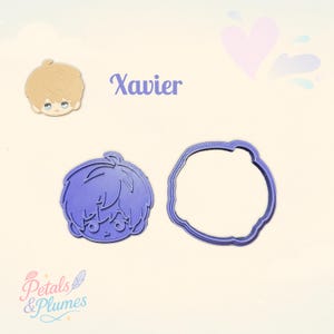 May include: A purple plastic cookie cutter set featuring a character head outline and a matching stamp insert. The design depicts a stylized anime-style boy with short hair. The text Xavier is printed in purple above the cutter pieces.