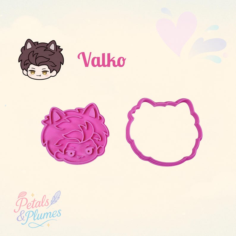 May include: A pink plastic cookie cutter set featuring a character with cat ears and a matching illustration labeled Valko. The set includes a detailed impression stamp and a separate outer cutting frame, both shaped like the character's head.