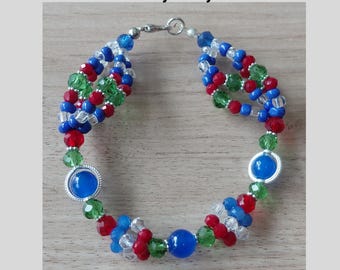 May include: A beaded bracelet featuring blue, red, green, and clear faceted beads with larger smooth blue spherical beads and silver-toned accents. The text Ide Of Yemaya Mayelewo and Made by AlagbaOmi is visible above and below the bracelet.