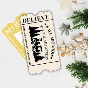 Pode incluir: Dois bilhetes em estilo vintage com o texto "BELIEVE" e "ALL ABOARD! THE POLAR EXPRESS." Um é creme, o outro dourado. Os bilhetes apresentam um comboio, árvores e estrelas, evocando um tema festivo.