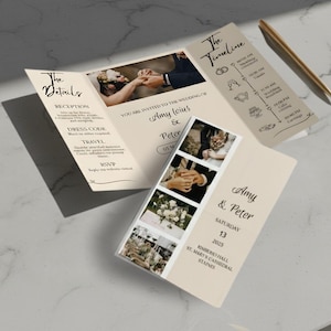 May include: A beige wedding invitation suite with a trifold design, featuring photos, text, and a timeline. The invitation includes the names "Amy & Peter", the date, and venue details. A gold pen rests nearby.