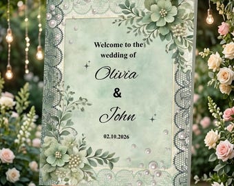 Op de afbeelding: Een welkomstbord voor een bruiloft op een ezel. Het bord heeft een mintgroene achtergrond met bloemen- en kanten accenten. De tekst luidt "Welkom bij de bruiloft van Olivia & John 02.10.2026". Decoratieve parels en bloemen sieren het bord.