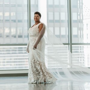 A pair of detachable cape veil  attached to either shoulder. They are an asymmetrical cascading shape. Shown in Lt Ivory.