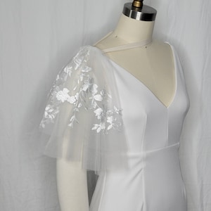 A pair of detachable, double layer puff sleeves, made of ultra soft tulle and floral lace.