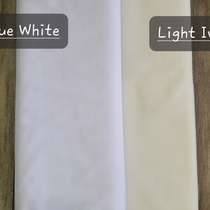 May include: Two fabric swatches, one labeled "True White" and the other labeled "Light Ivory". The swatches are placed side-by-side on a woodgrain surface.