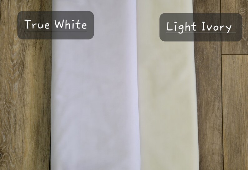 May include: Two fabric swatches, one labeled "True White" and the other labeled "Light Ivory". The swatches are placed side-by-side on a woodgrain surface.
