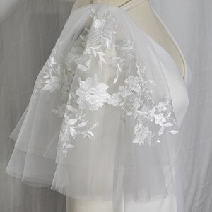 A pair of detachable, double layer puff sleeves, made of ultra soft tulle and floral lace.