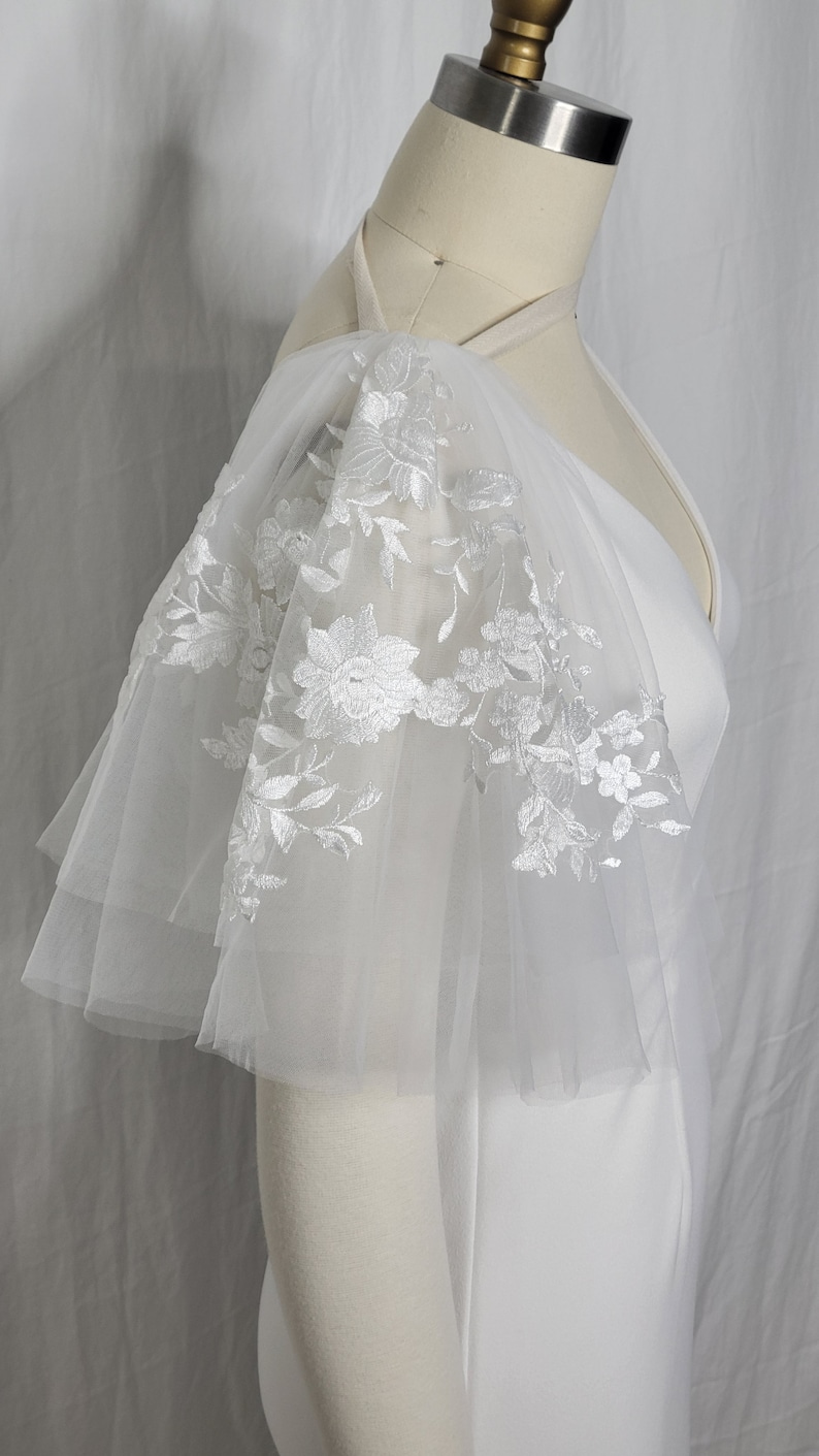 A pair of detachable, double layer puff sleeves, made of ultra soft tulle and floral lace.