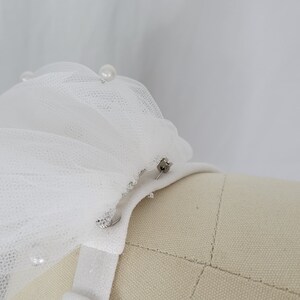 A pair of detachable, double layer puff sleeves, made of ultra soft tulle and floral lace.