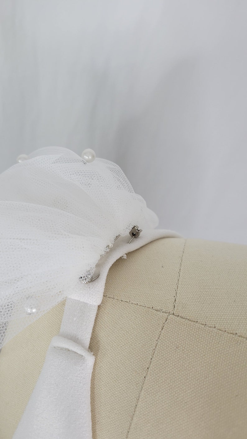 A pair of detachable, double layer puff sleeves, made of ultra soft tulle and floral lace.