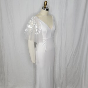 A pair of detachable, double layer puff sleeves, made of ultra soft tulle and floral lace.