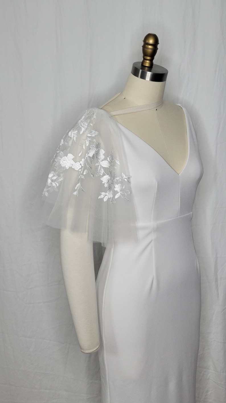 A pair of detachable, double layer puff sleeves, made of ultra soft tulle and floral lace.