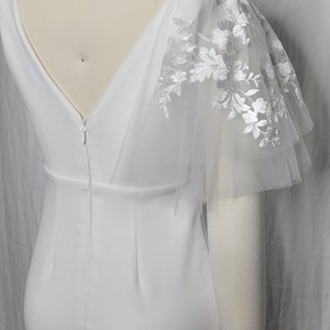 A pair of detachable, double layer puff sleeves, made of ultra soft tulle and floral lace.