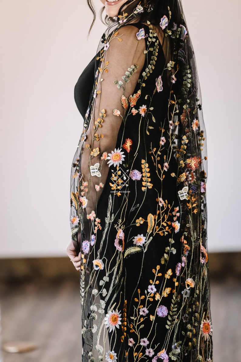 A single layer oval veil gathered to a metal hair comb, made from a black soft tulle embroidered with multi-color autumnal floral.