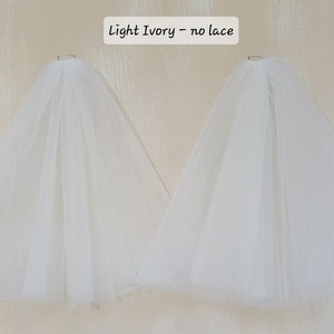 A pair of detachable, double layer puff sleeves, made of ultra soft tulle and floral lace.