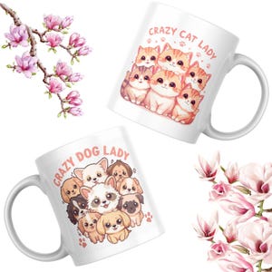 May include: Two white ceramic mugs with cartoon illustrations. One mug features a group of orange and brown cats with the text "Crazy Cat Lady." The other mug has a group of dogs with the text "Crazy Dog Lady." Pink magnolia flowers are in the background.