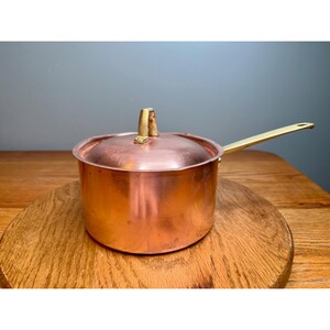 Paul Revere limited edition copper  2 quart saucepan featuring a brass handle and matching lid