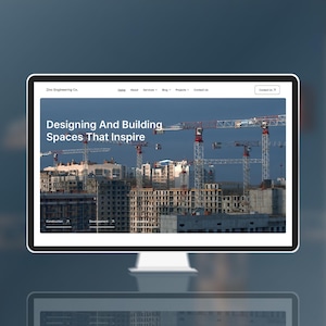 May include: A computer monitor displaying the Zinc Engineering Co. website. The homepage features the text Designing And Building Spaces That Inspire over an image of multiple construction cranes towering above unfinished concrete buildings.