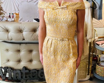 Vestido tubo con cinturón y hombros descubiertos con brocado dorado de los años 60