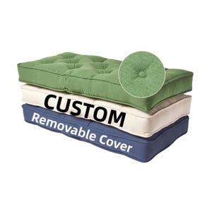 May include: Three custom cushions with removable covers are stacked. The top cushion is green, the middle is off-white, and the bottom is navy blue. The green cushion has a button-tufted design. The text "CUSTOM Removable Cover" is printed on the middle and bottom cushions.