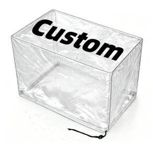 May include: A transparent, rectangular plastic cover with the word "Custom" printed in bold black letters. It features a drawstring closure and appears waterproof. The product is designed to protect items from the elements.