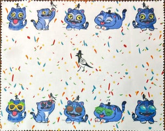 May include: A white fabric with a repeating pattern of blue cartoon cats wearing hats and sunglasses, with a bird and confetti. The cats have various expressions, and the confetti is in red, orange, and yellow.