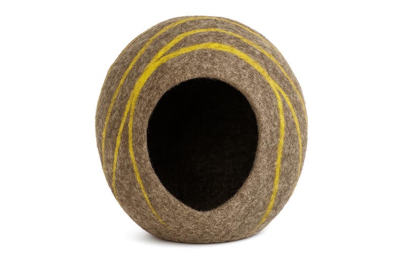 May include: A brown pet bed with a round shape and a large opening. The bed is decorated with yellow stripes that run vertically along the exterior. The interior is dark, creating a cozy space for a small animal.