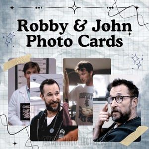 May include: Photo cards featuring images of Robby and John. The cards are arranged on a textured, light-colored background with decorative elements. The text "Robby & John Photo Cards" is prominently displayed.
