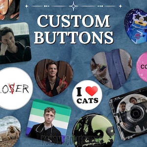 May include: A collection of custom buttons with various designs, including a heart-shaped button with a sweater design, a button with the text "I ❤️ CATS", and a button with the text "LOSER". The image also includes a CD case.