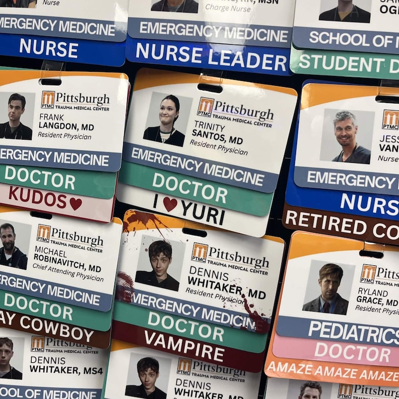 May include: A selection of employee ID badges from Pittsburgh Trauma Medical Centre. The badges display photos, names, and titles such as "Doctor," "Nurse," and "Nurse Leader." Some badges have playful text like "Kudos" and "Vampire."