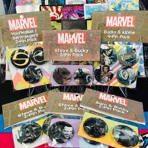 May include: Marvel pin packs featuring various characters, including Steve, Bucky, and others. The packs include 2-pin, 3-pin, and 4-pin sets. Each pack has the Marvel logo and character names. The pins have images of the characters.