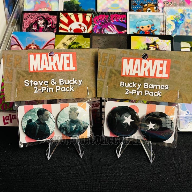 May include: Two Marvel 2-pin packs featuring Steve & Bucky and Bucky Barnes. The Steve & Bucky pack includes pins with images of the characters. The Bucky Barnes pack has black pins with a white star. The Marvel logo is visible.