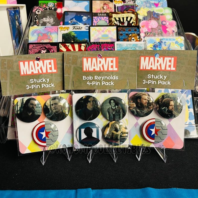 May include: Marvel pin packs featuring characters from the Marvel universe. The packs include 3-pin and 4-pin sets, with images of characters and logos. The packaging features the Marvel logo and character names.