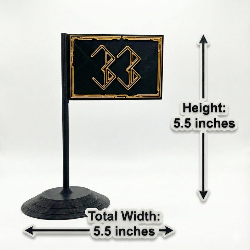 May include: A black and gold flag-shaped decoration with the number "33" in a stylized font. The flag is 5.5 inches in height and 5.5 inches wide, mounted on a black stand.